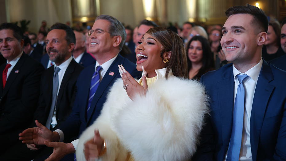 Musician Nicki Minaj laughs during remarks by U.S. President Donald Trump at the Treasury Department's Trump Accounts Summit with U.S. Treasury Secretary Scott Bessent (L) at the Andrew W. Mellon Auditorium on January 28, 2026 in Washington, DC.