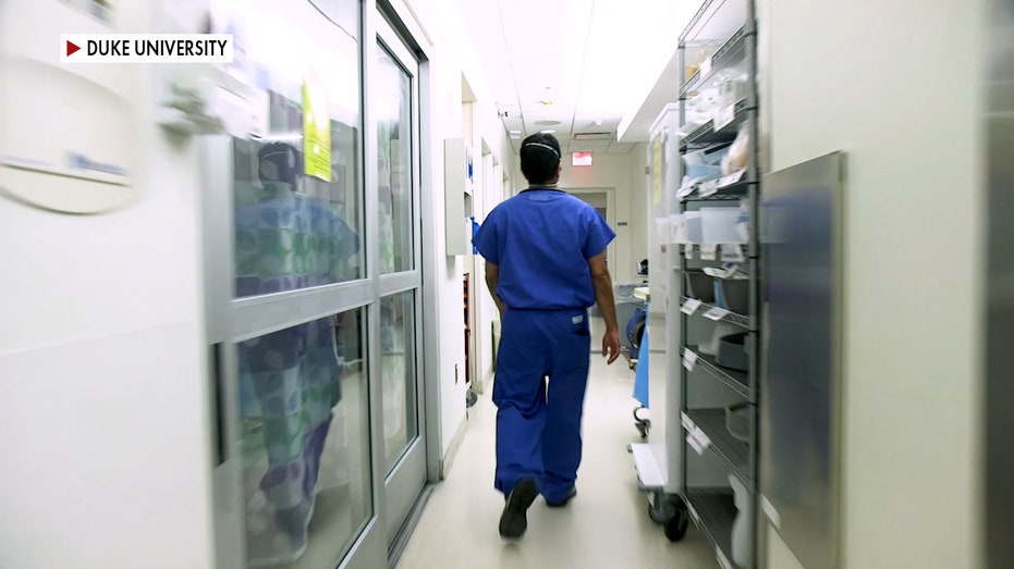 A healthcare worker in a hallway